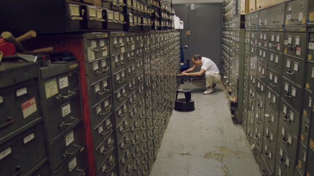 Last remaining archivist Jeff Roth searches the New York Times morgue. Photographer: Ben Wolf